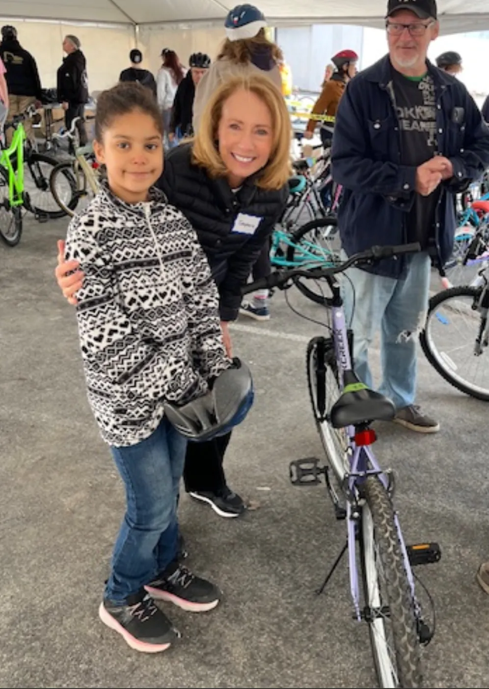 A volunteer with a young bike recipient on Bike Day