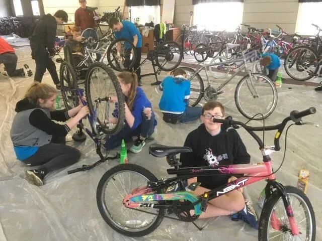 Volunteers cleaning and repairing bikes