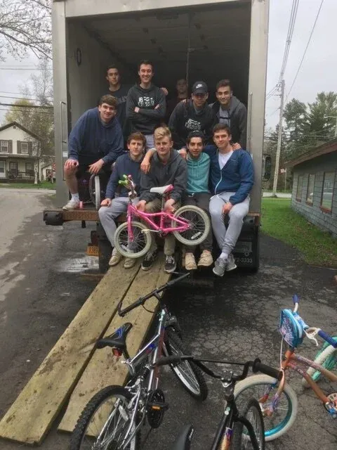 Volunteers loading bikes into a truck